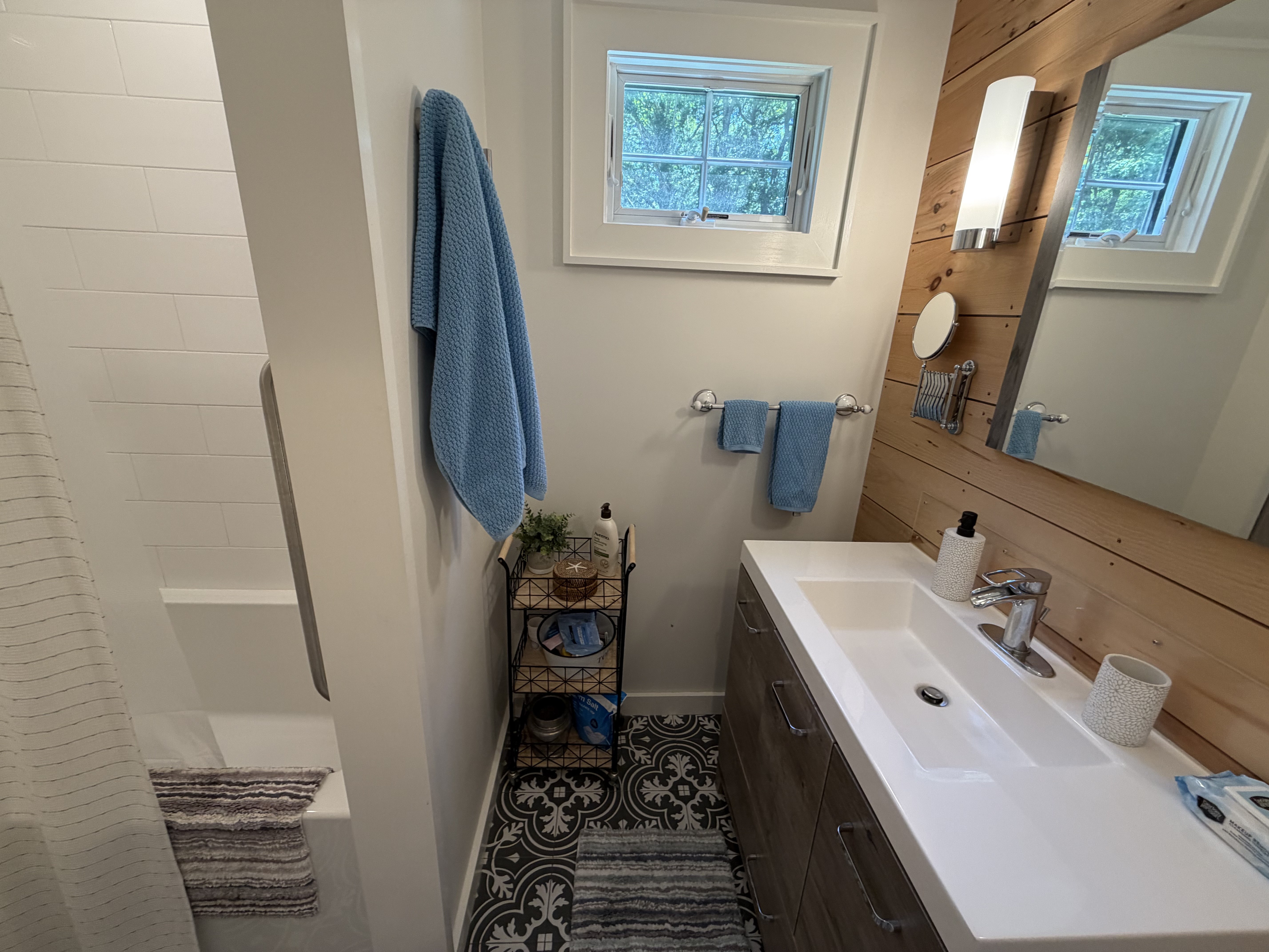 Bright bathroom with shower and blue towels
