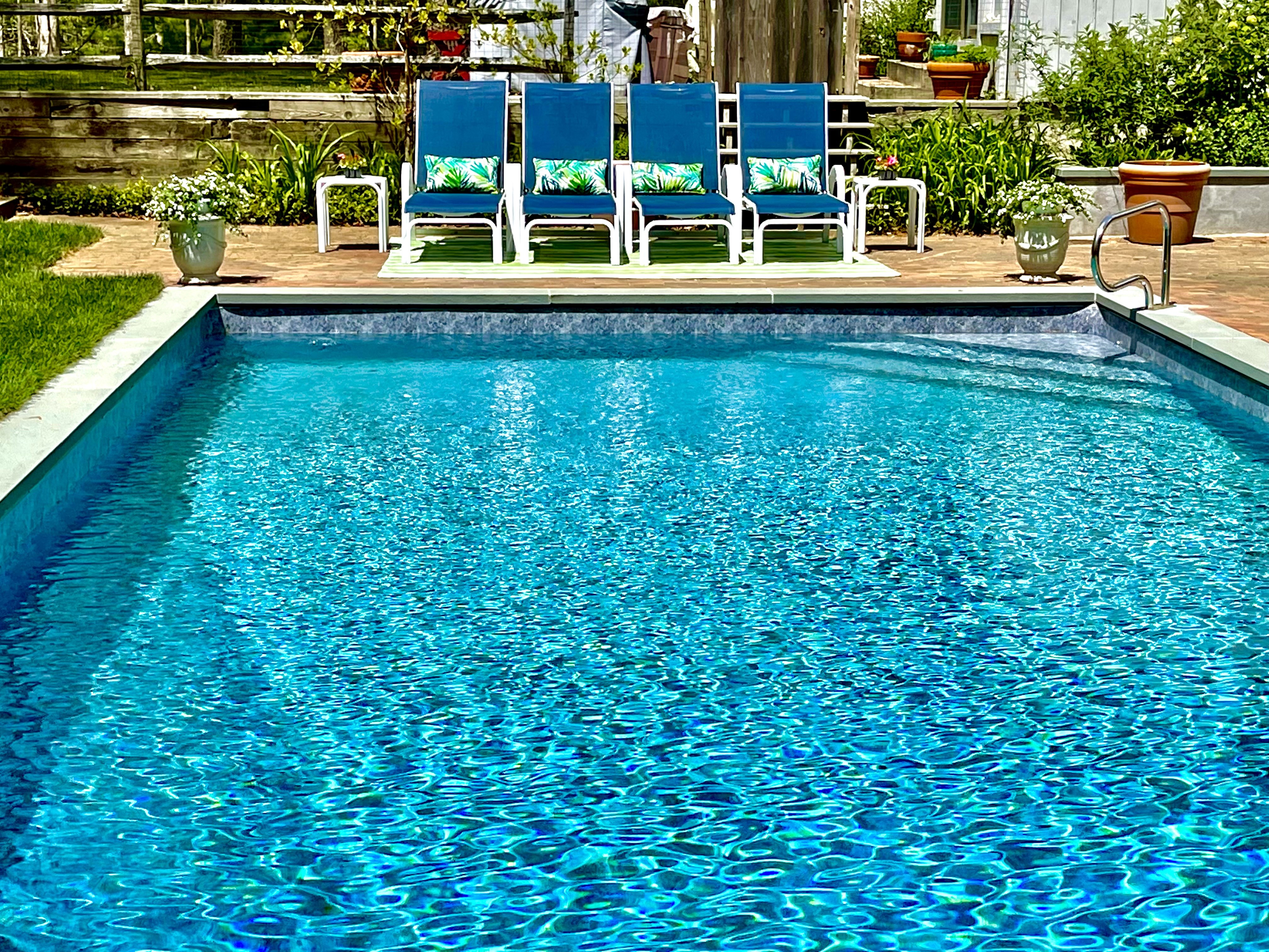 Private pool with bright blue loungers ready for a summer afternoon