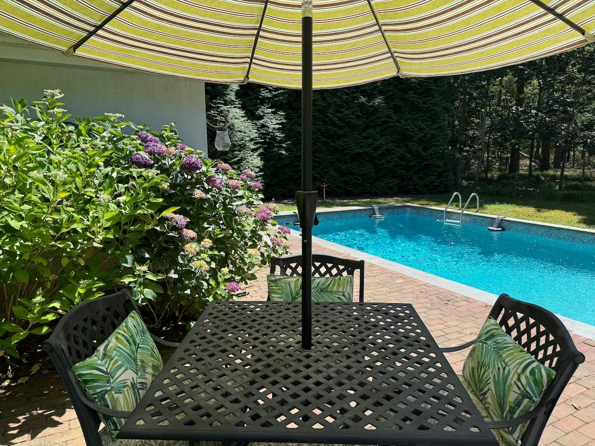 Poolside table and private pool at Beachglass Barn
