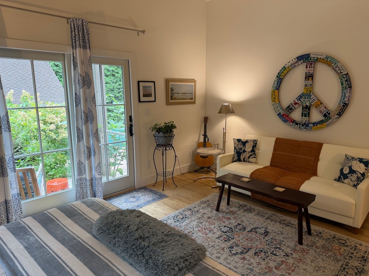 Sunlit sitting area and fireplace in the Beachglass Barn suite