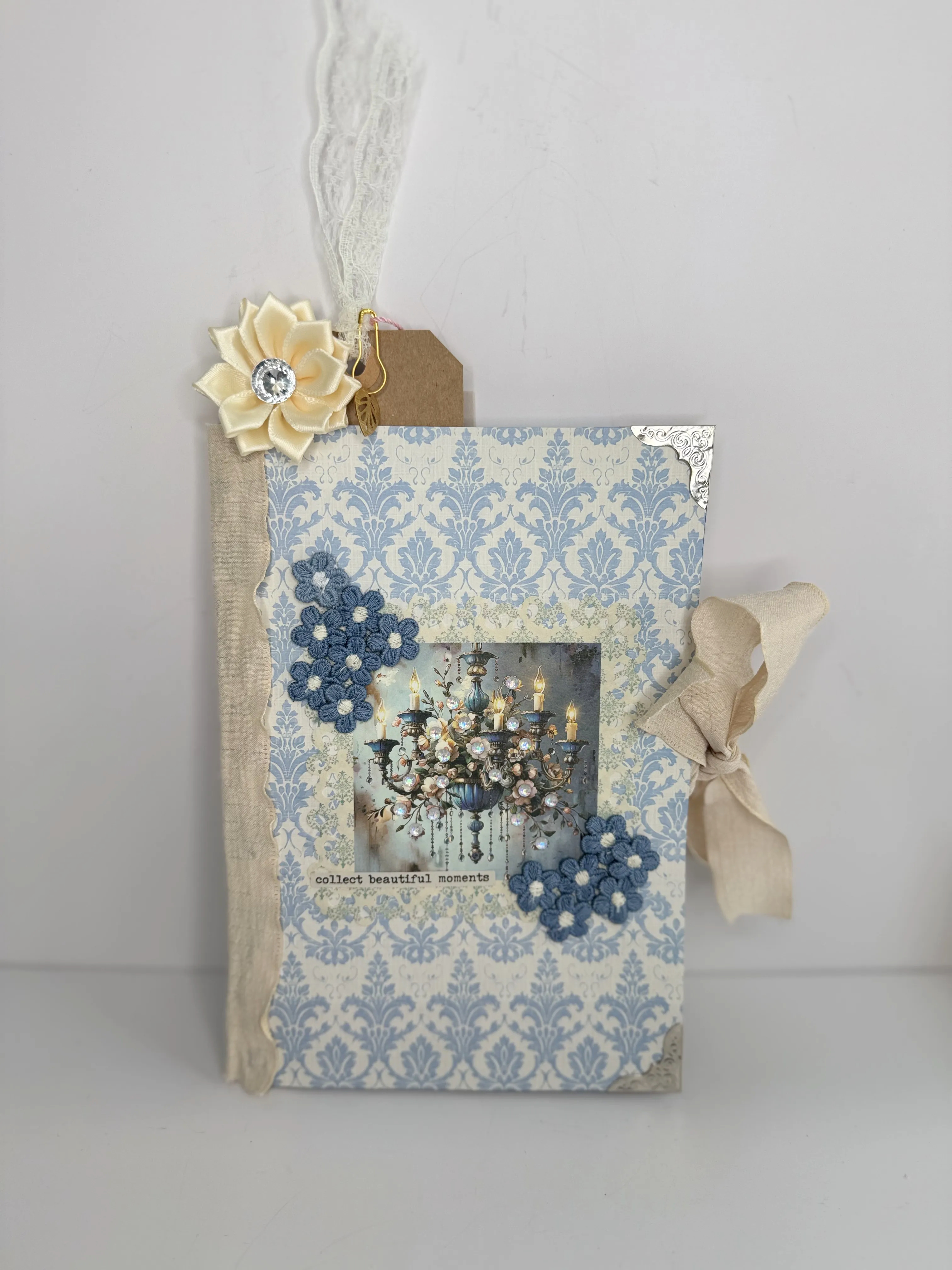 Blue floral journal cover with a detailed handmade embellishment