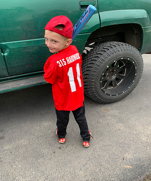 Young Syracuse Little League player in a 315 Hardwoods jersey