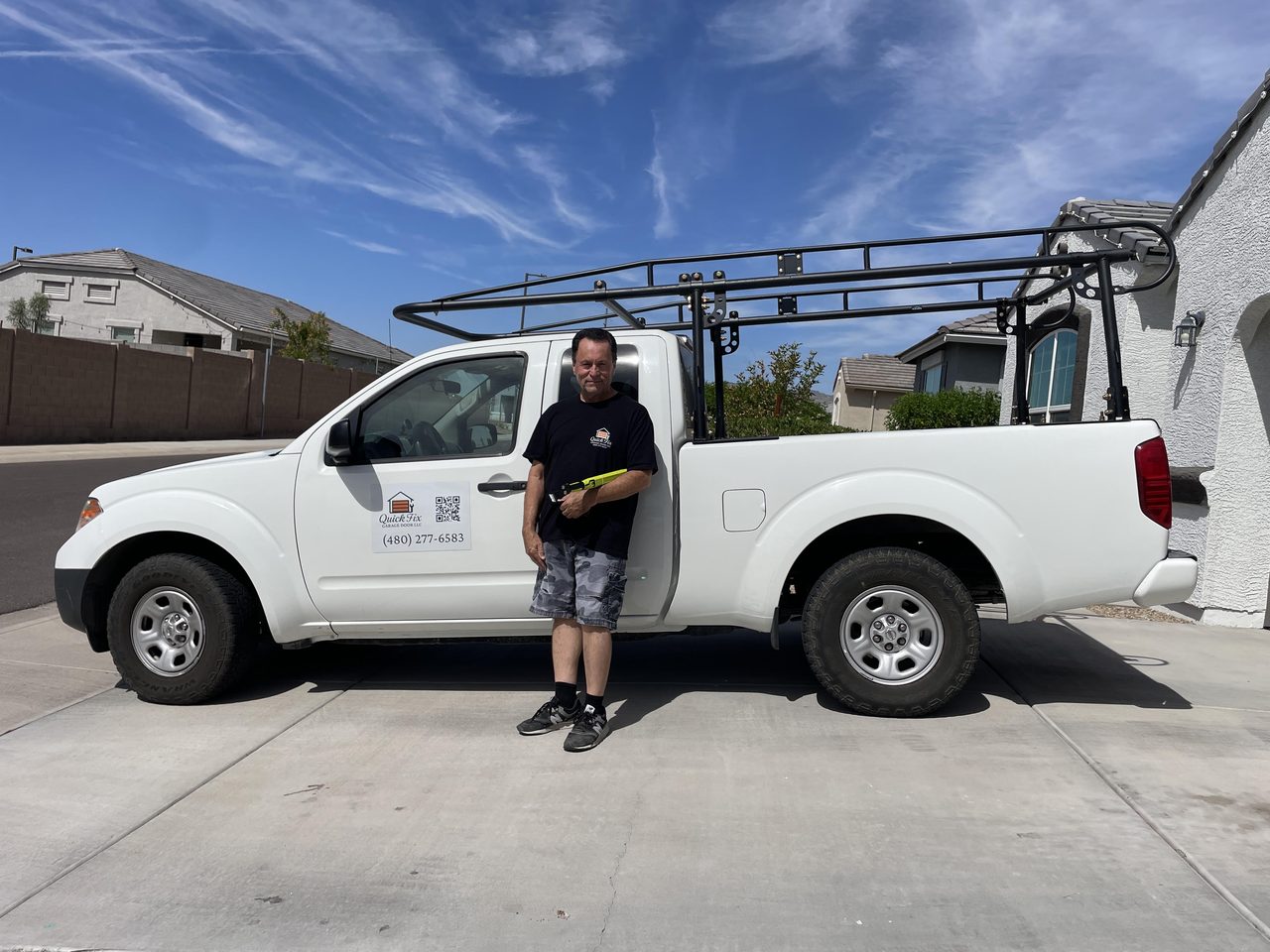Jorge beside the Quick Fix Garage Door work truck