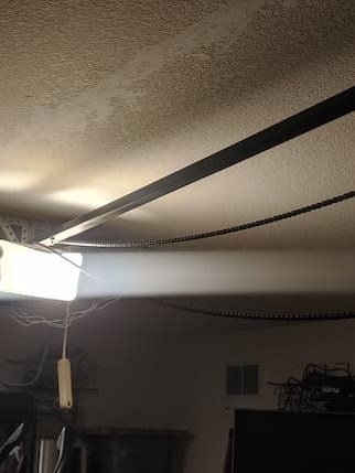 Garage door opener installed above a residential garage door