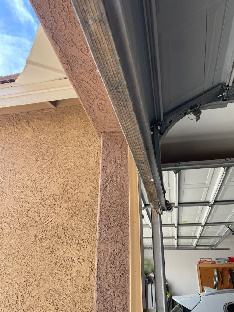 Worn bottom garage door seal before the Goodyear repair