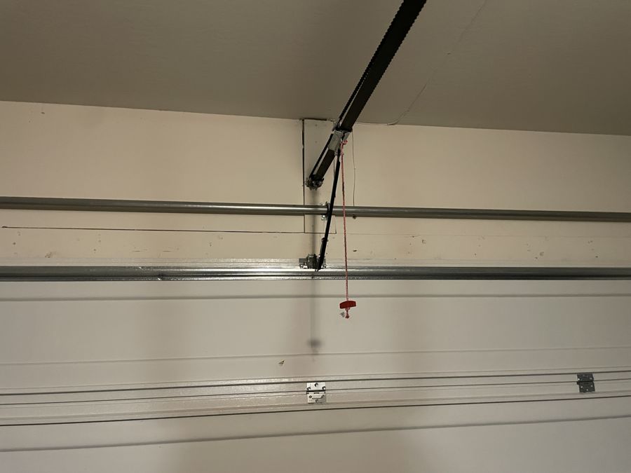 Replaced J-arm bracket connecting the opener arm to the garage door
