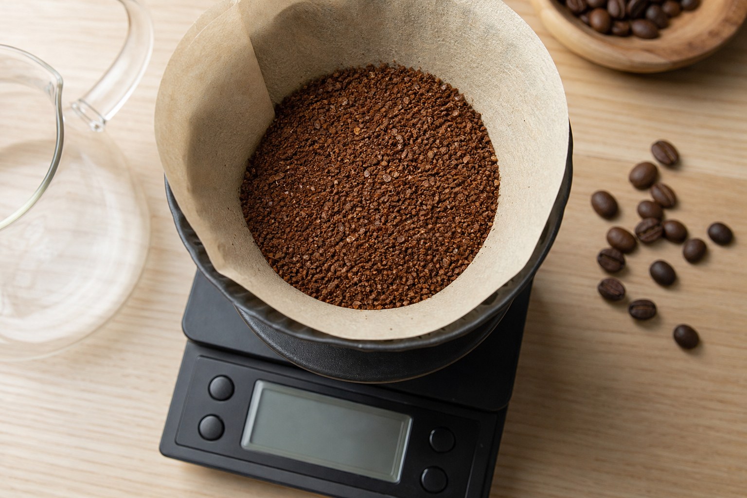 Medium-ground coffee in a paper filter basket on a kitchen scale