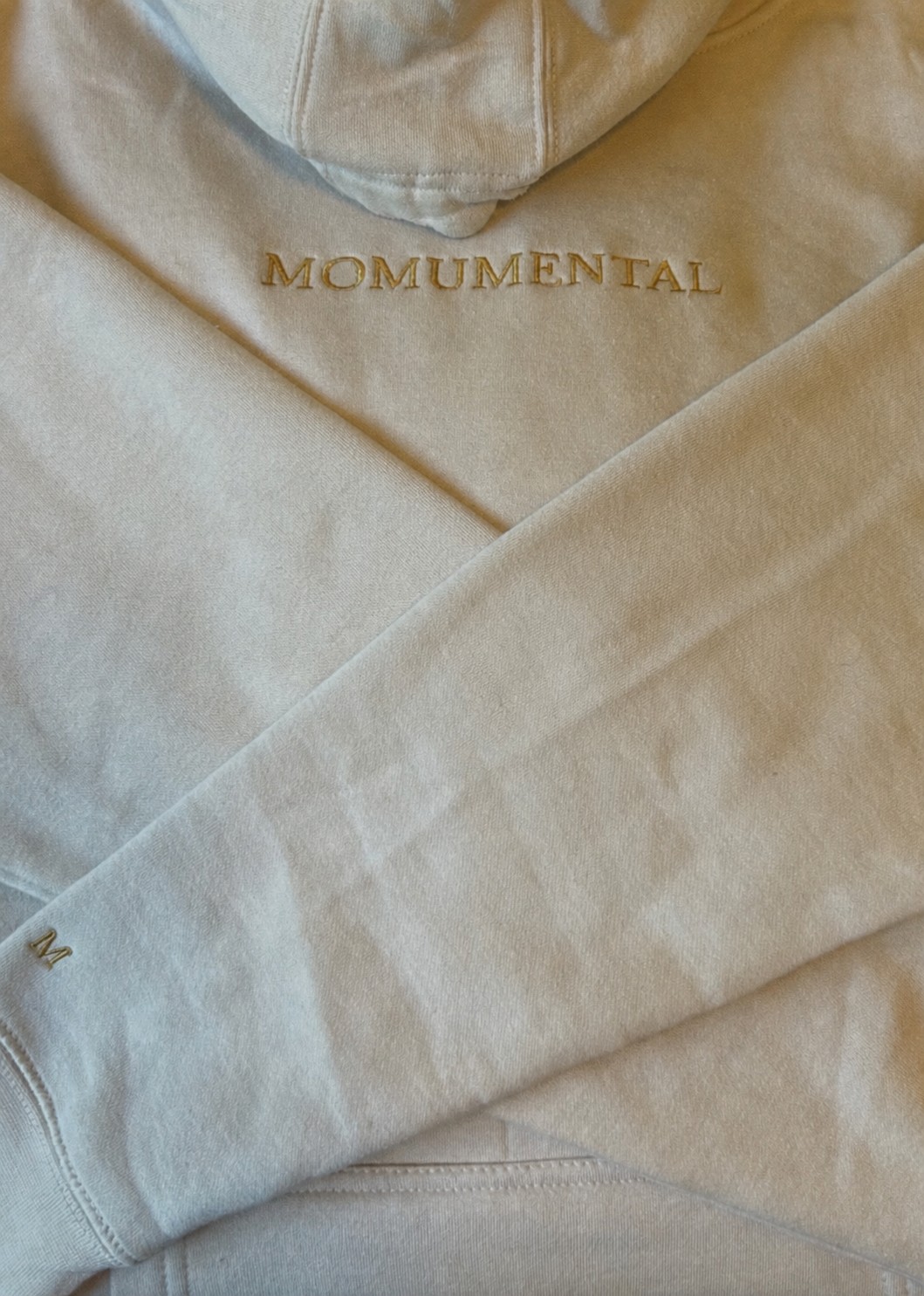 Momumental embroidery on a bone hoodie