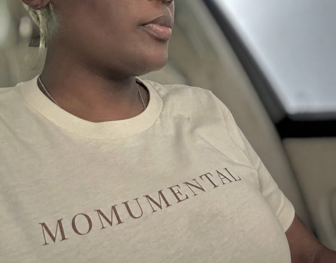 Woman wearing a Momumental Signature Tee