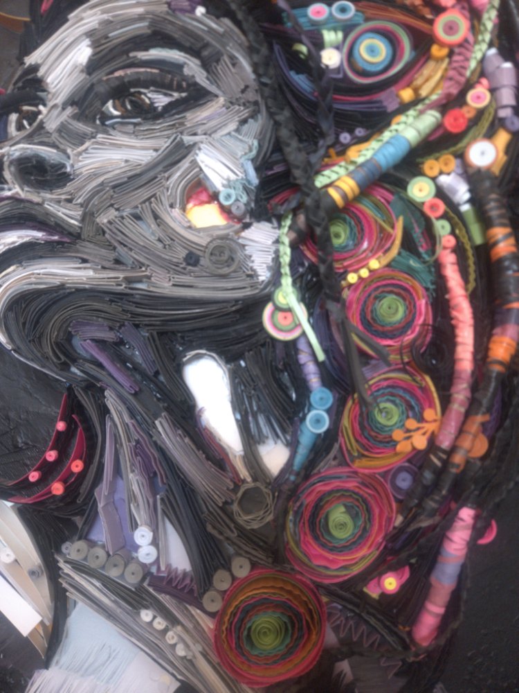 Close-up of a dimensional handmade paper portrait by Kairee Cardoso