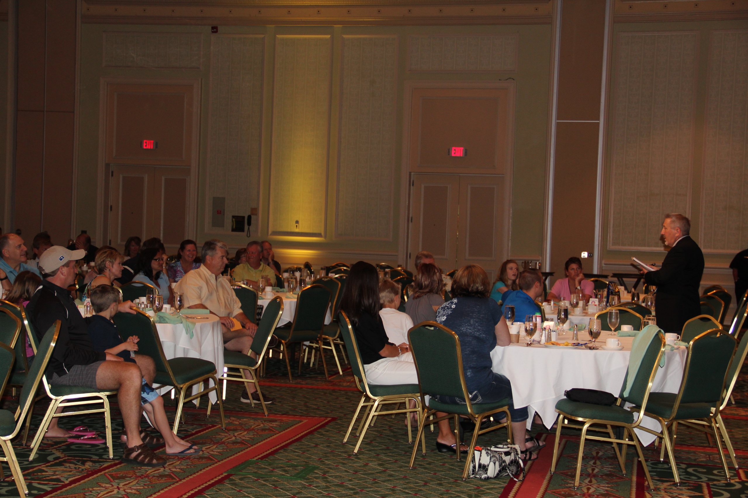 boB performing for guests during a banquet in a ballroom