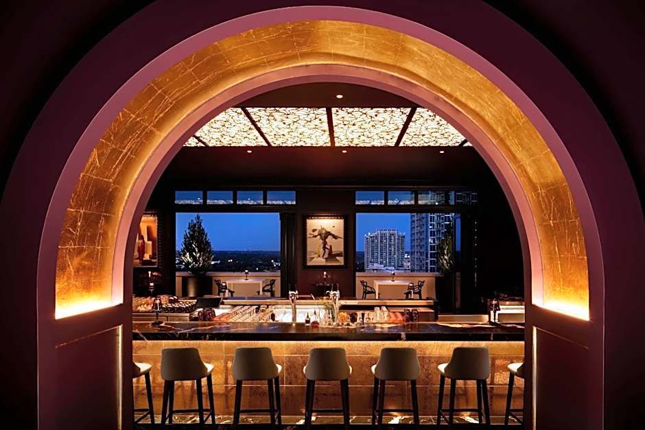 An illuminated gold arch framing a bar and seating area