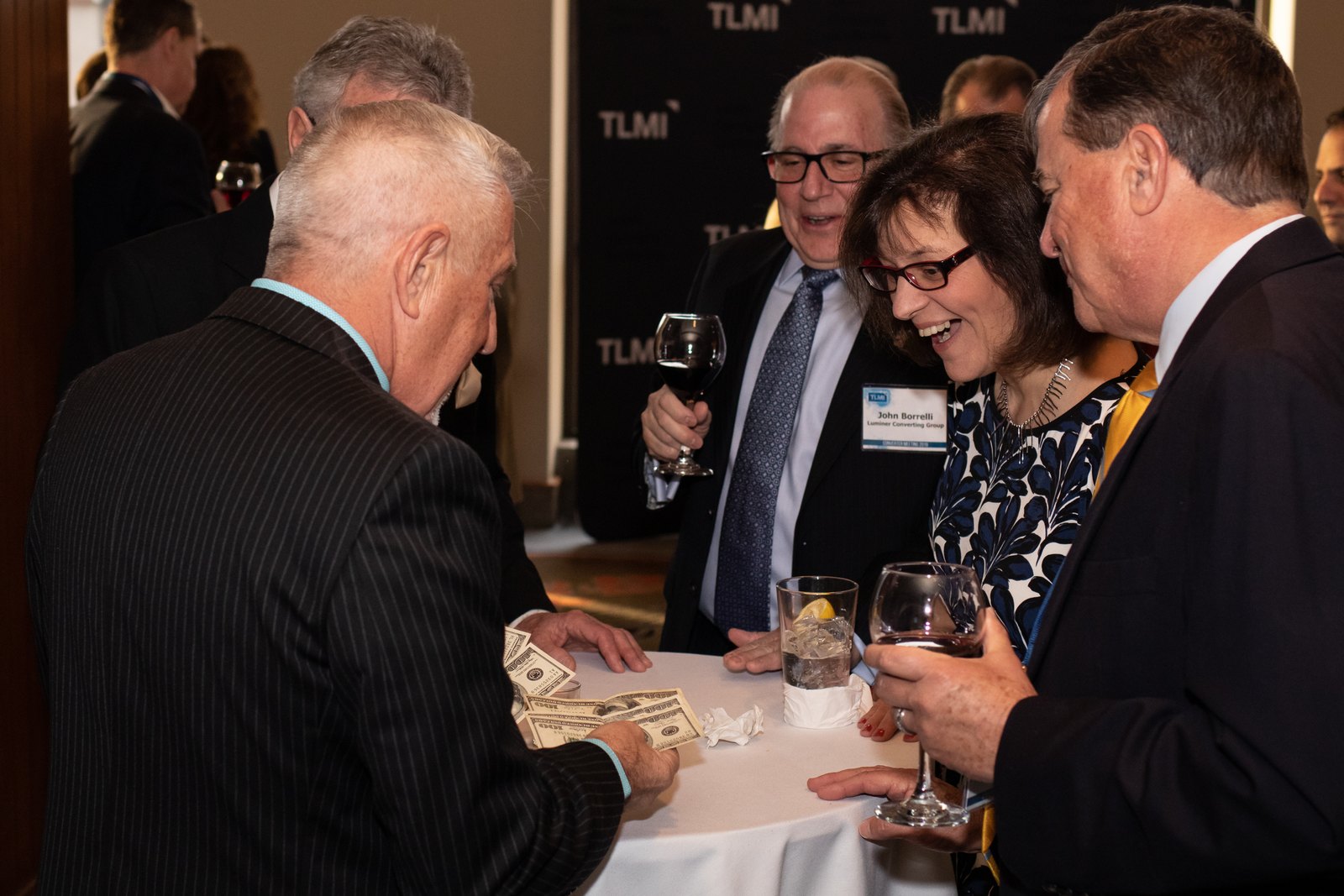 boB performing close-up magic with guests at a corporate reception