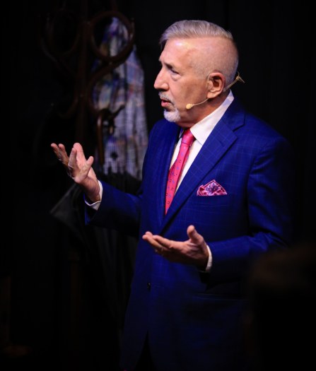boB Taylor performing in a blue suit and pink tie