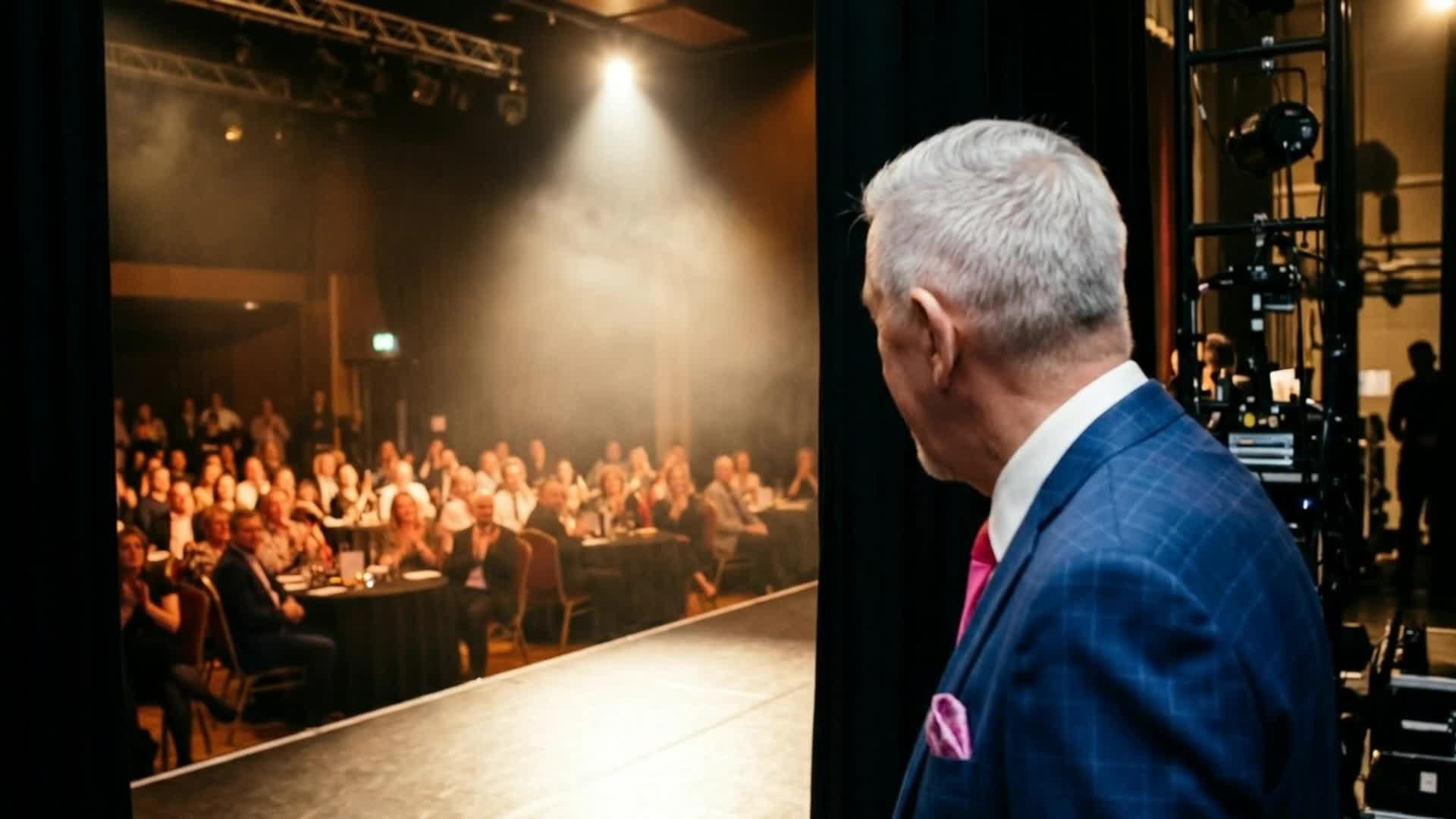 boB on stage in front of event guests