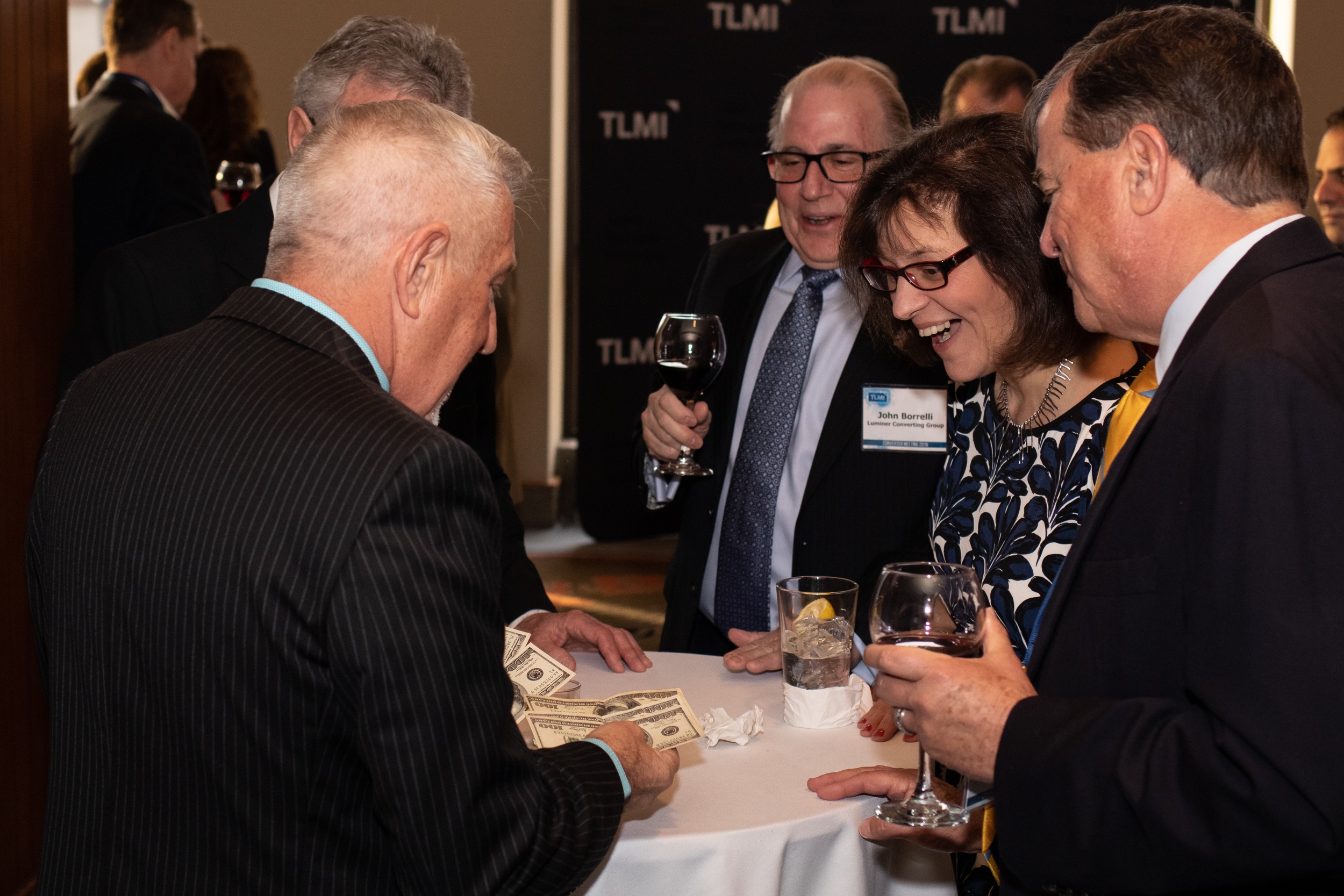 boB performing close-up magic with guests at a corporate reception