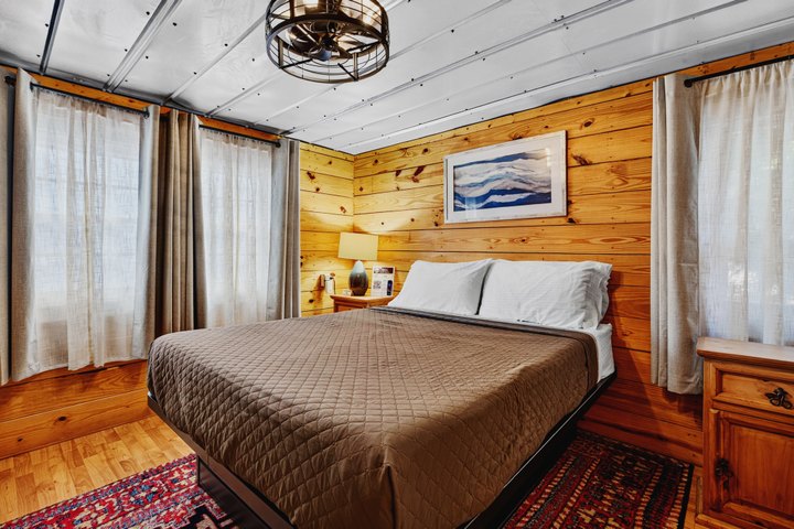 Farmhand Cabin: Bedroom with wood-paneled walls