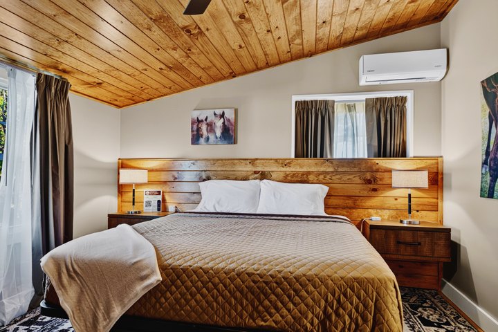 Crestwood: Bedroom with wooden headboard and timber ceiling