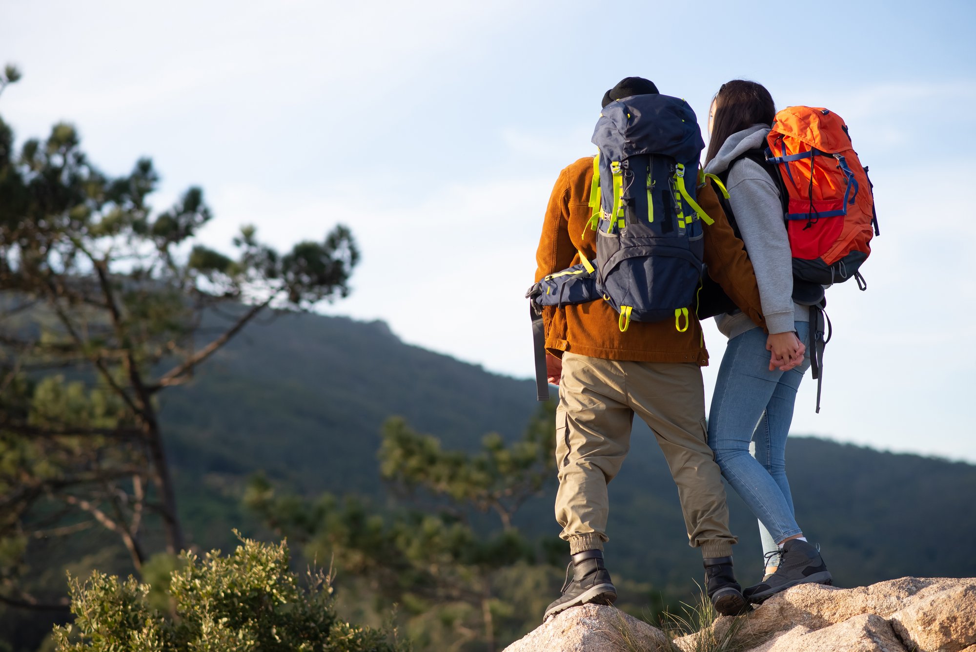 Two hikers enjoying a mountain overlook