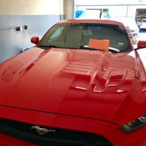 Red vehicle at the Auto Hail Zone repair shop