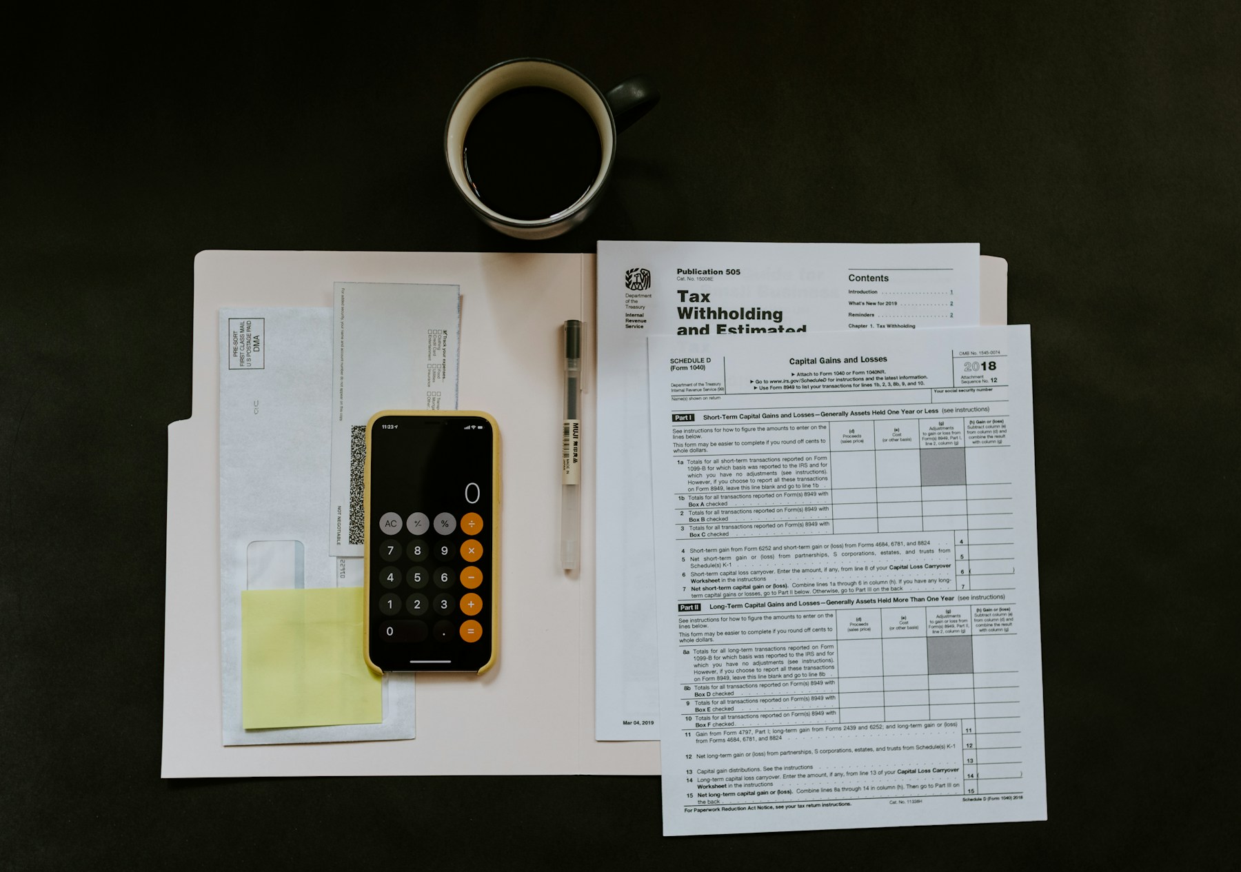 Calculator, financial documents and a ledger arranged for recordkeeping