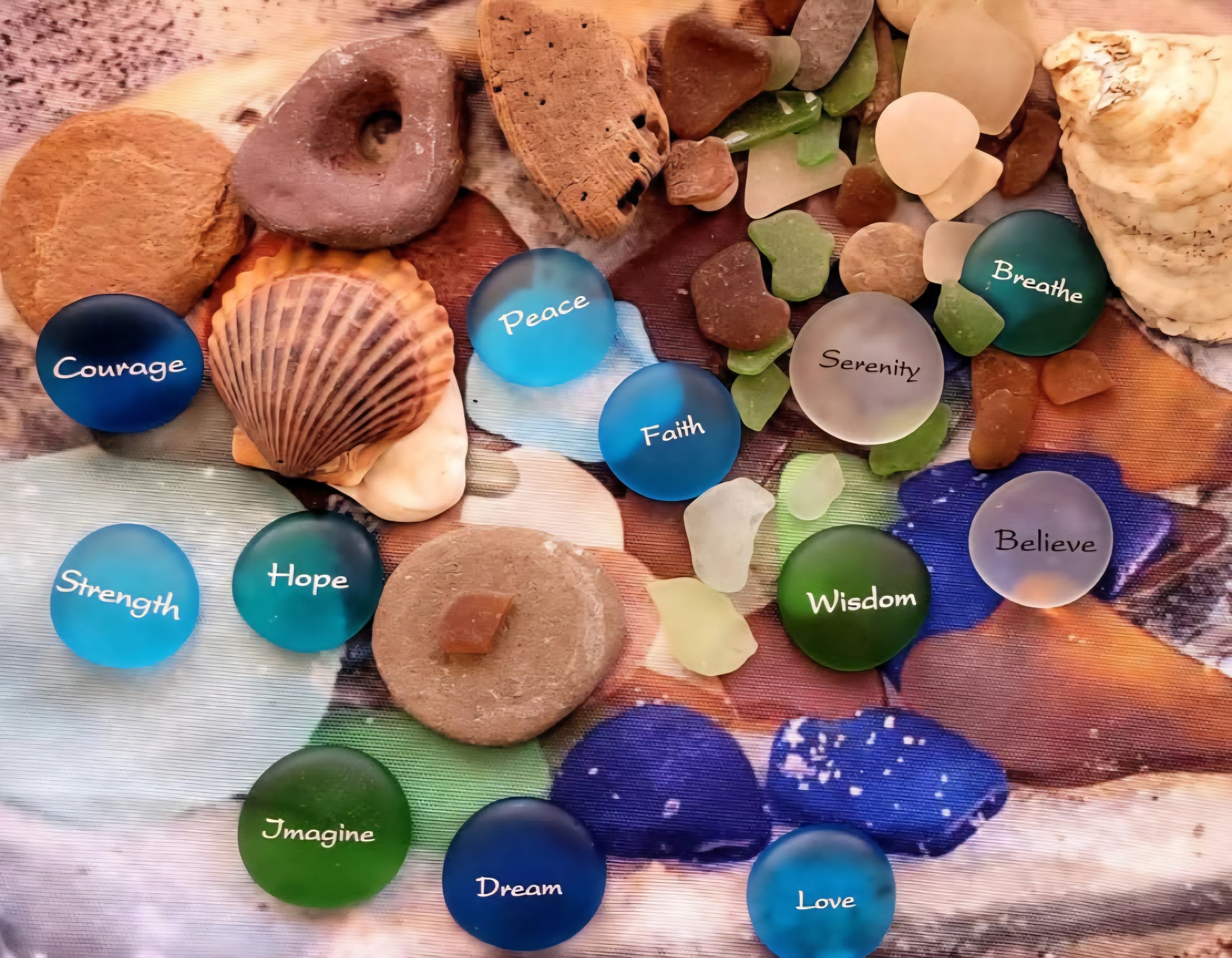 Sea glass, shells, and small stones gathered on a painted wooden surface