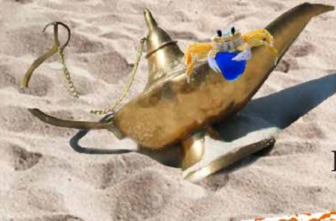 A crab beside a piece of blue sea glass on the sand