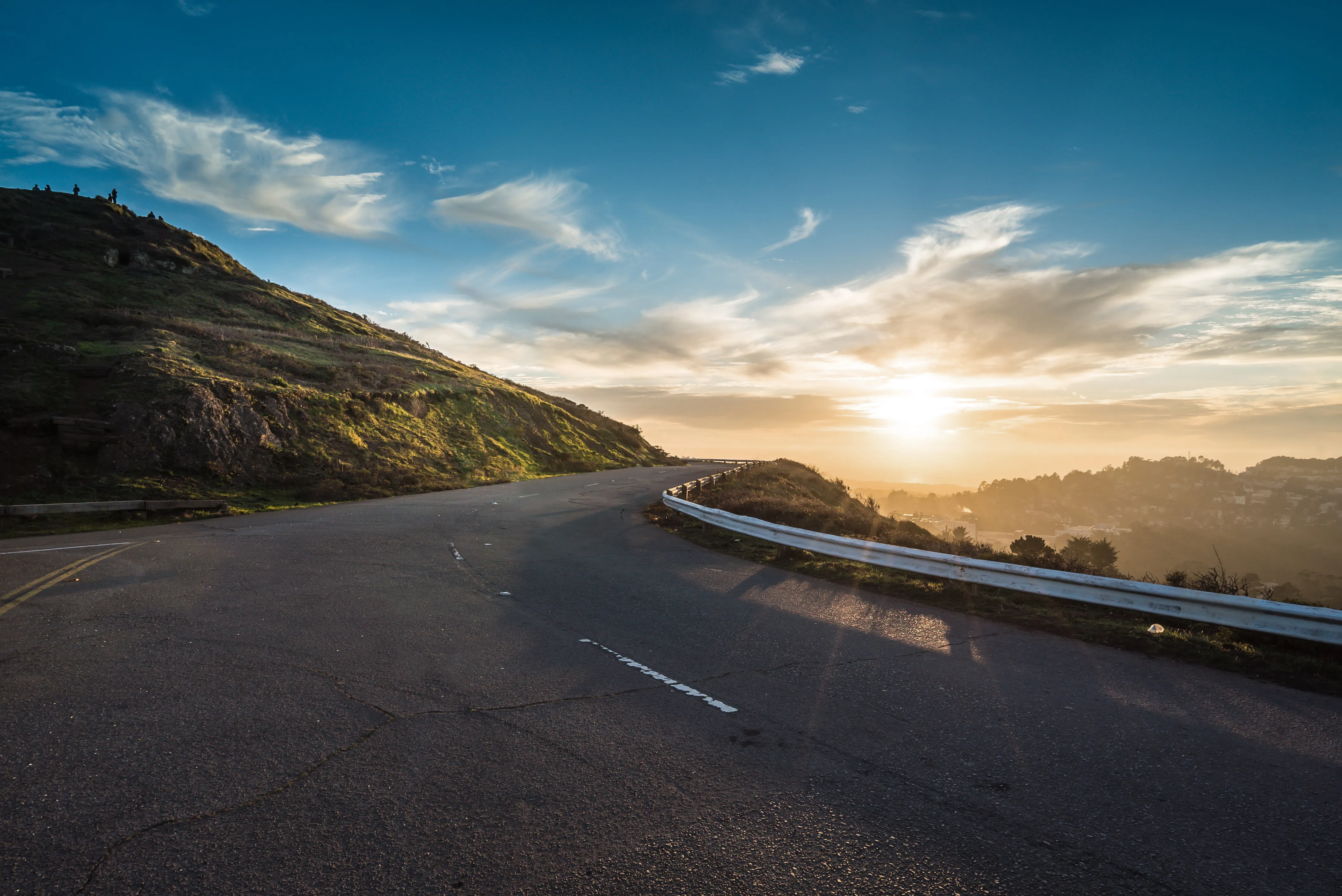 A winding road along the coast at sunset