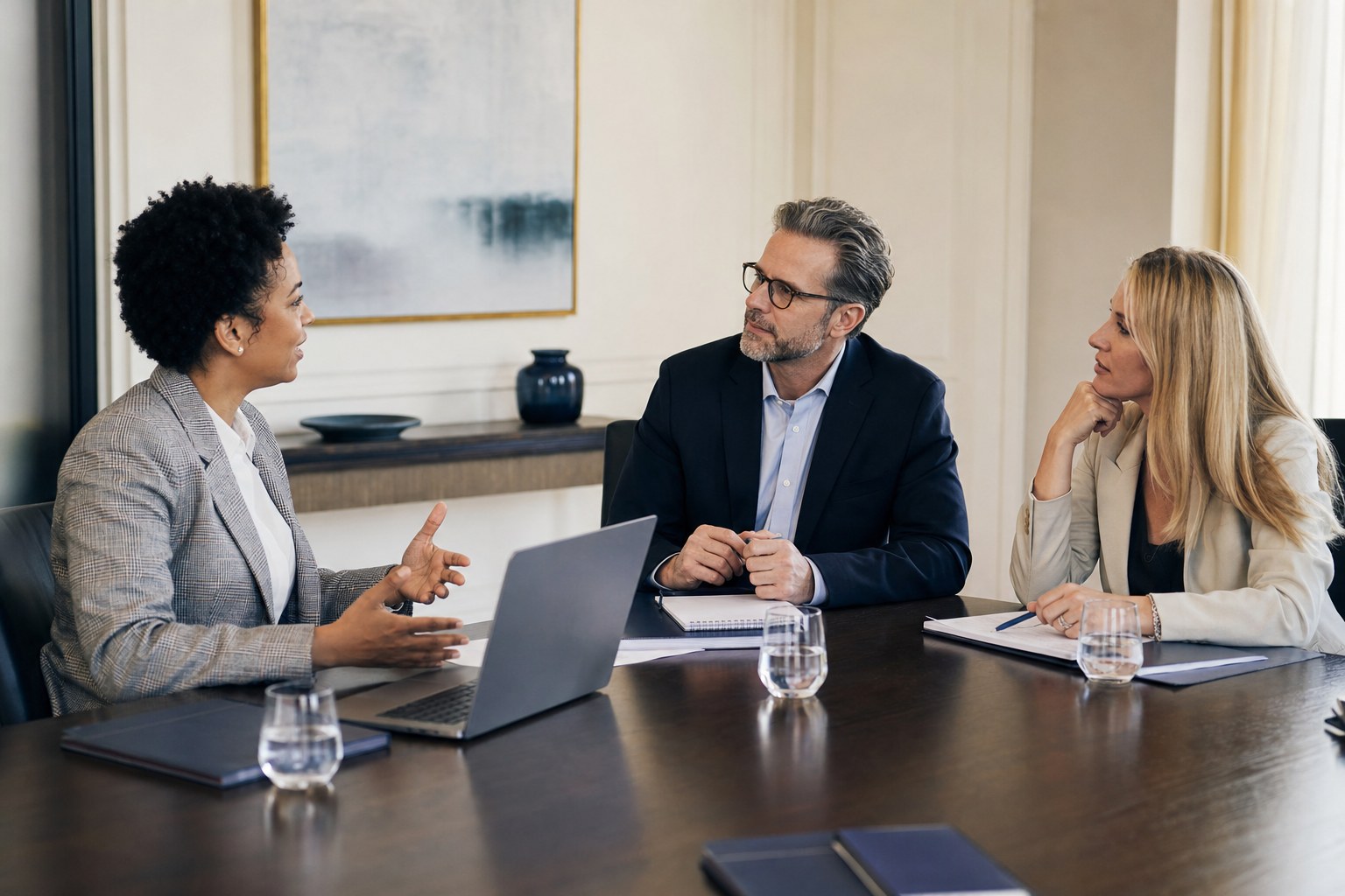 Communications professionals discussing a plan in a meeting room