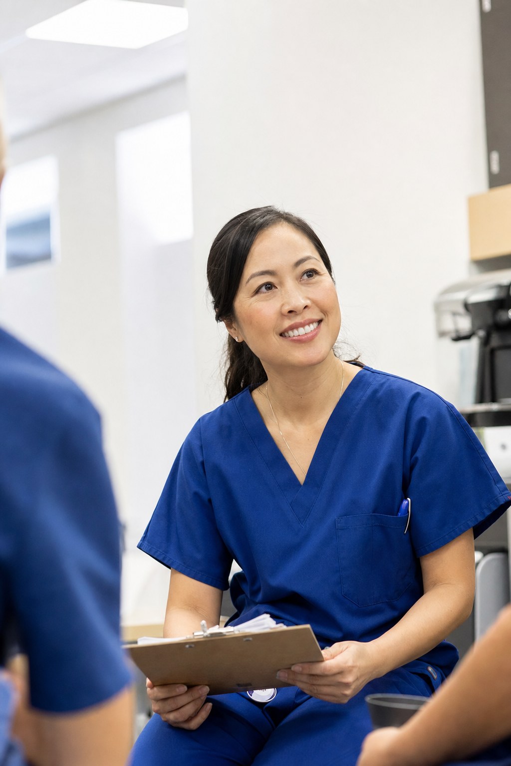 Healthcare professional holding a clipboard in a clinical hallway