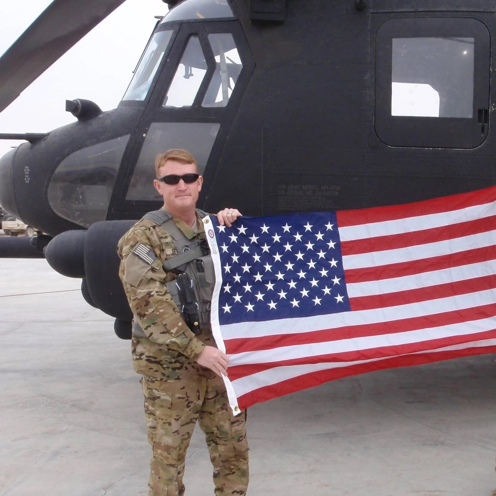 Travis DeWitt standing beside a military aircraft, reflecting on the experience that shaped his leadership approach.