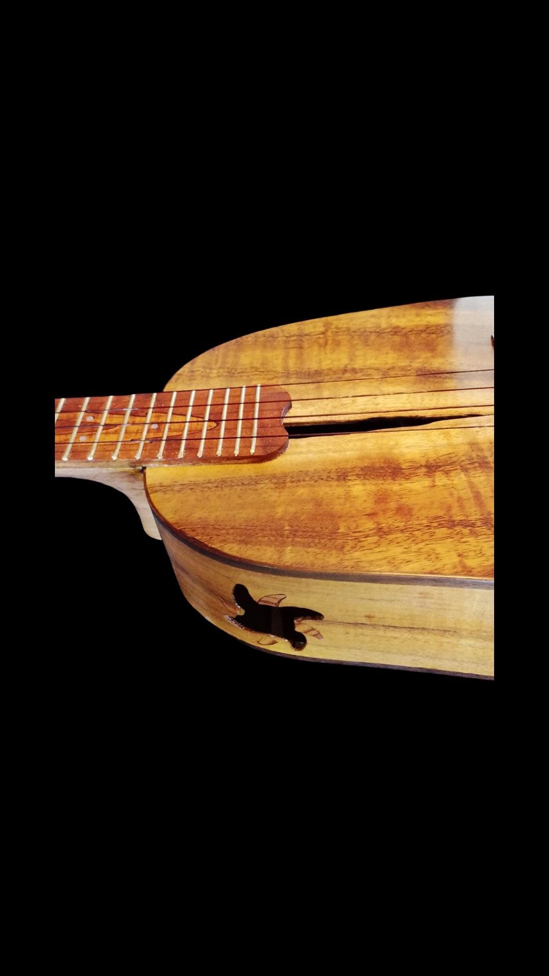 Close wood detail of a live-edge koa ukulele