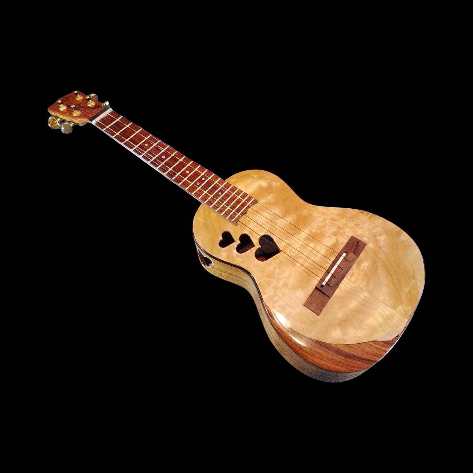 Koa tenor ukulele with flame maple top and heart sound holes