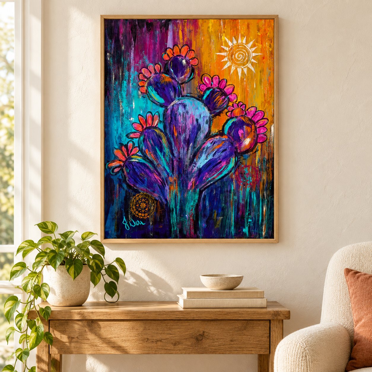 Wild & Radiant by Jennifer Narr hanging in a sunlit nook above a wooden table, beside a plant and armchair