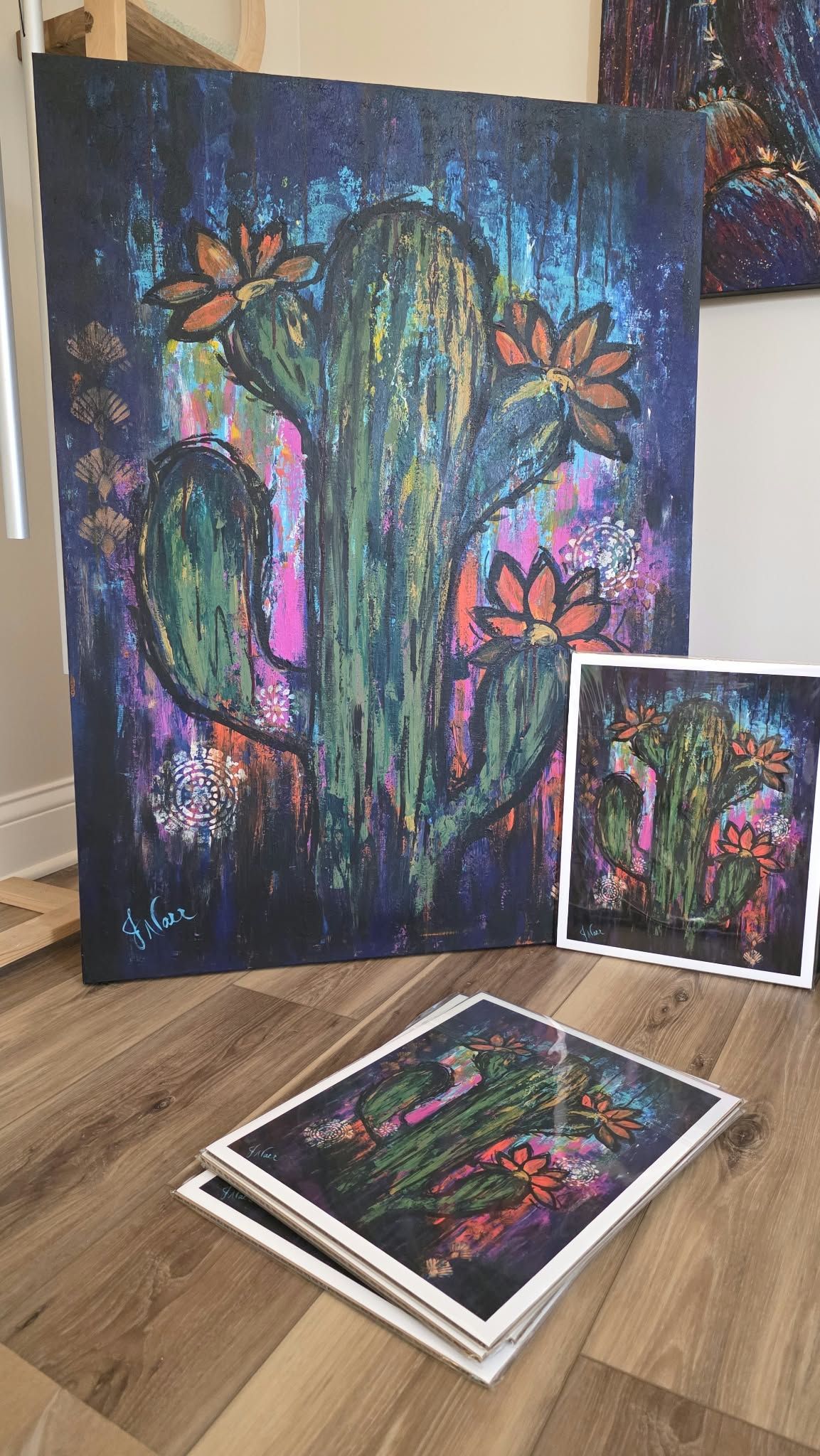 Jennifer Narr’s colorful cactus painting displayed alongside fine art prints