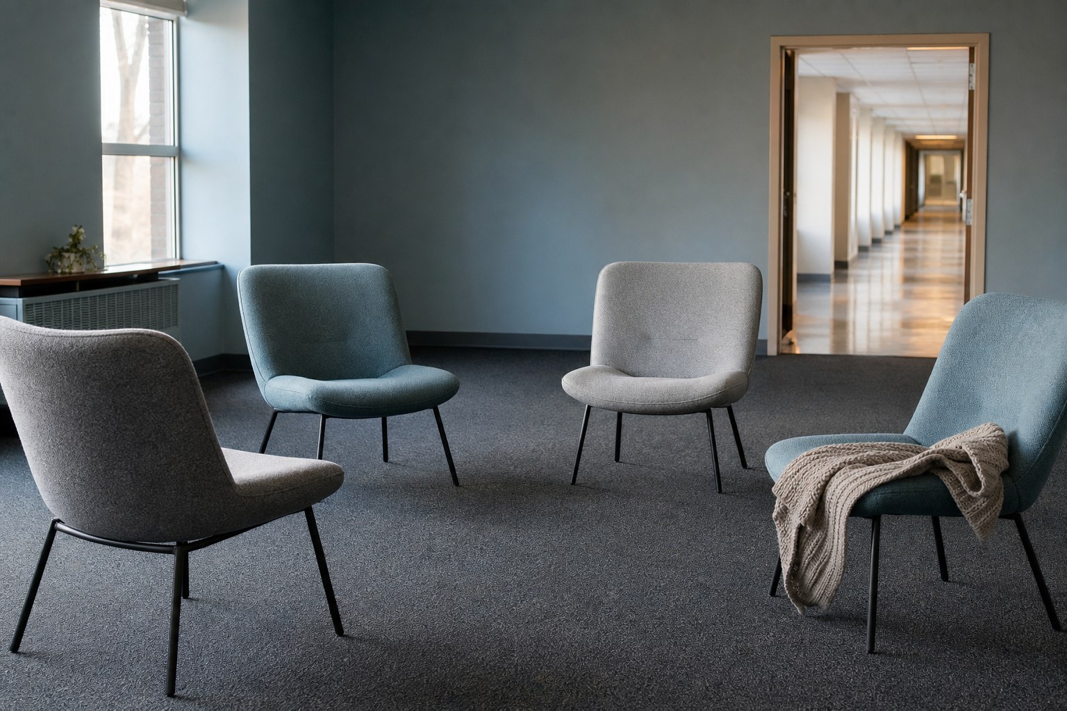 An empty community room with soft chairs after a gathering