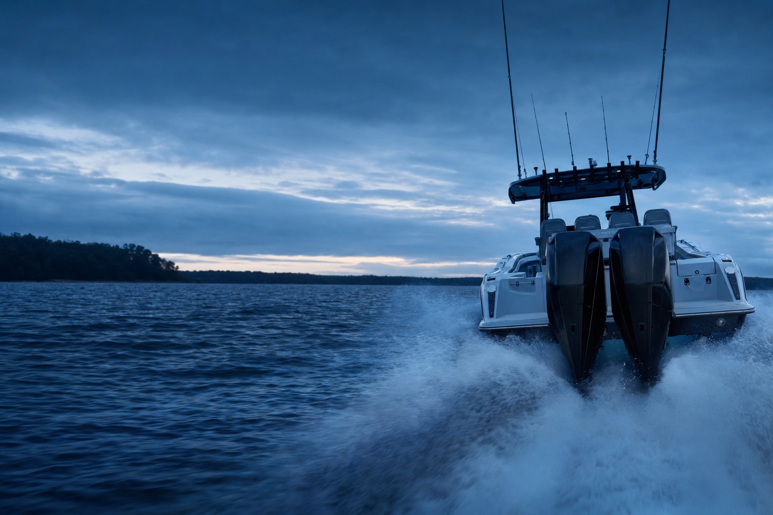 Twin outboard engines powering a fishing boat across open water