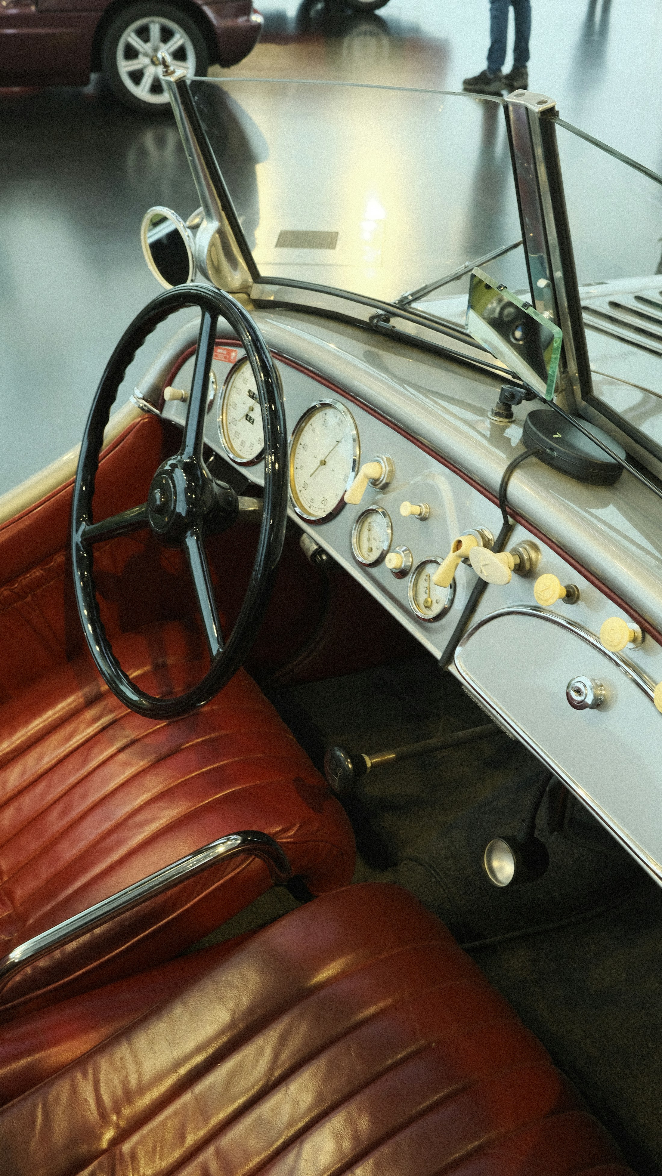 Restored vintage car interior with analog gauges and red leather seating