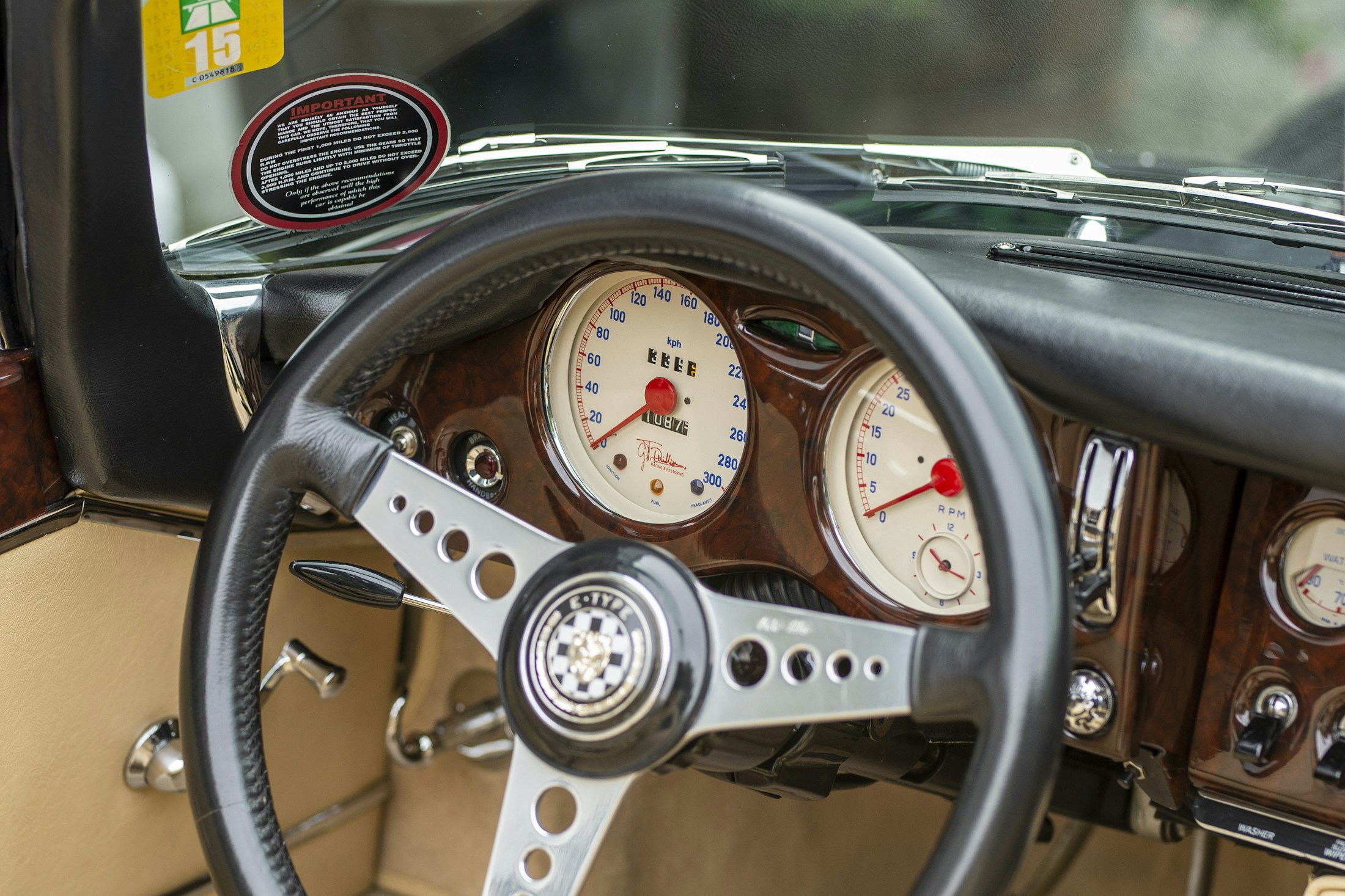 Vintage car dashboard with steering wheel and analog gauges
