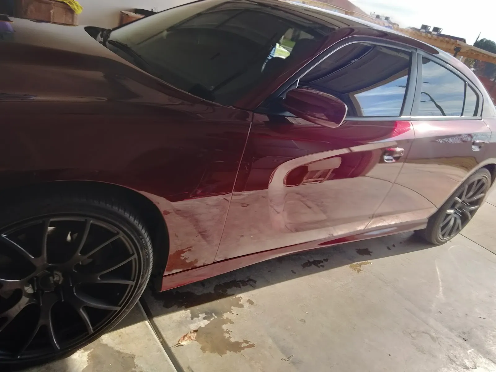 Dark vehicle receiving careful exterior detailing work