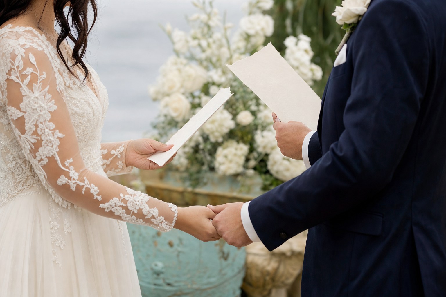 A couple holding hands and their handwritten vows during a wedding ceremony