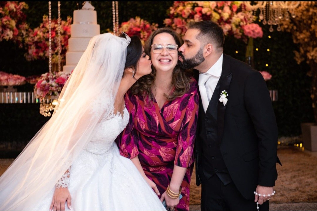 Newlyweds sharing a joyful moment with their officiant