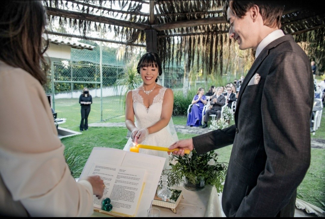 A couple listening during an outdoor wedding ceremony