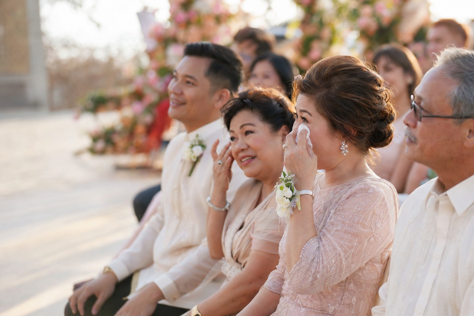 Guests listening joyfully during an outdoor wedding ceremony