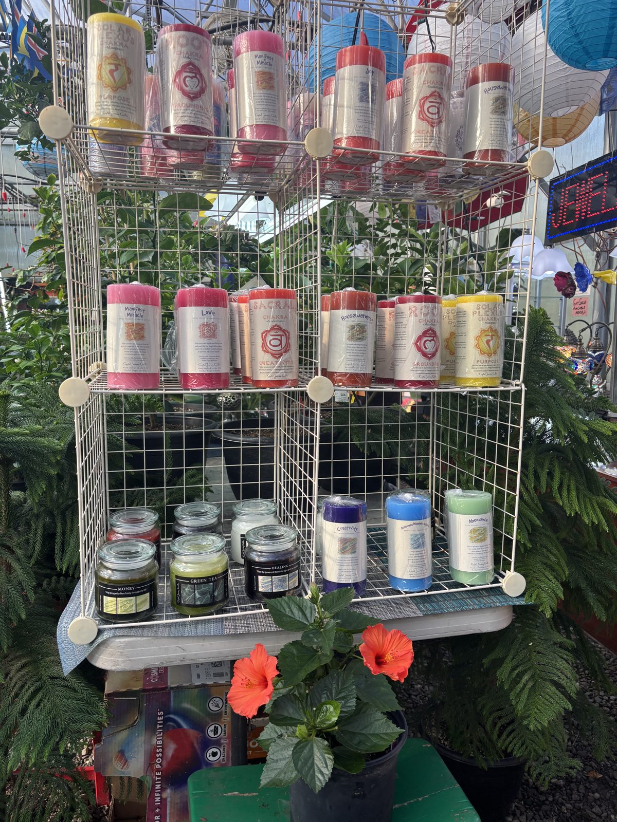 Colorful herbal pillar candles on display at Mile 5.2 Greenhouse