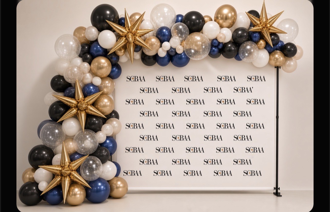 Navy, white, and gold organic balloon garland with gold stars around a branded backdrop