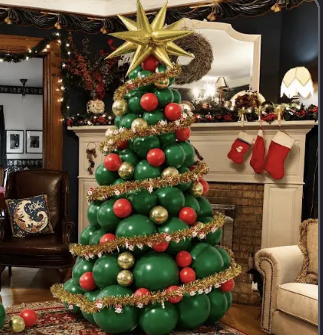 Green balloon Christmas tree with red ornaments, gold garland, and a gold star