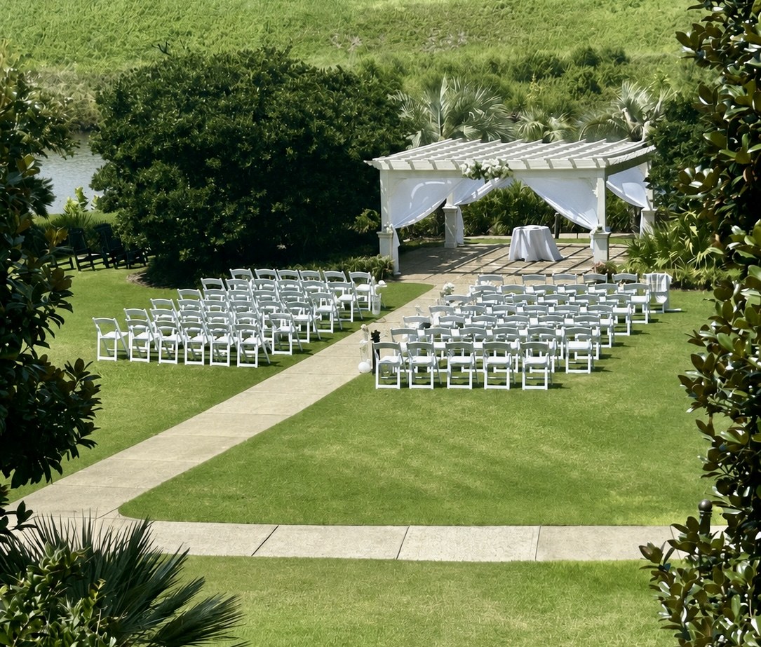 White fabric draping on an outdoor ceremony pergola