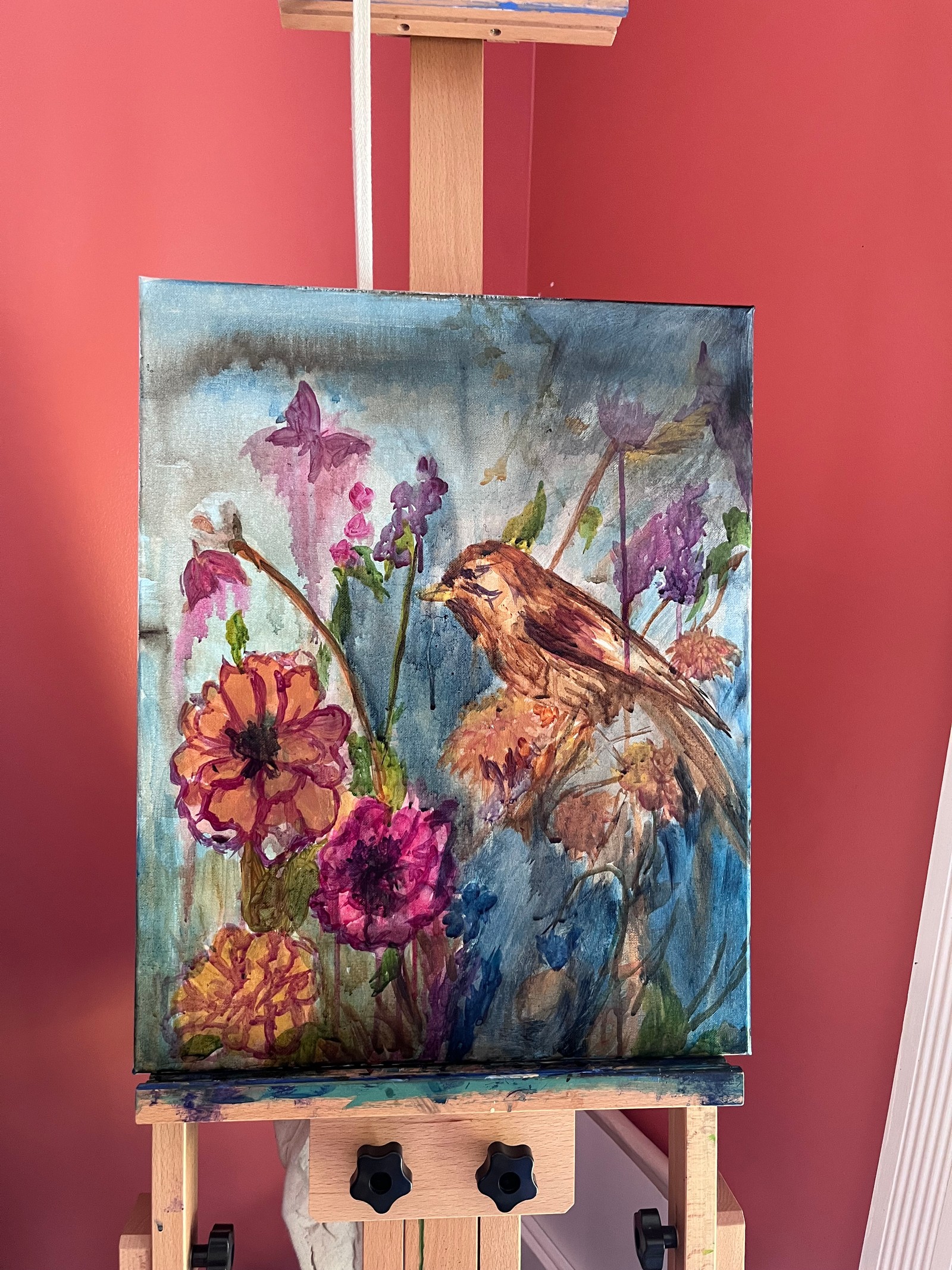 Where the Garden Sings in progress on the easel, with richer flower colors and emerging bird details