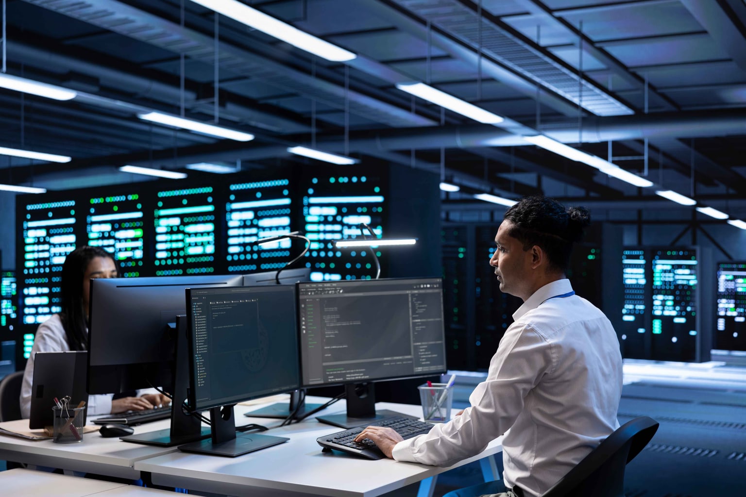 Technology operations specialist reviewing systems in a data center
